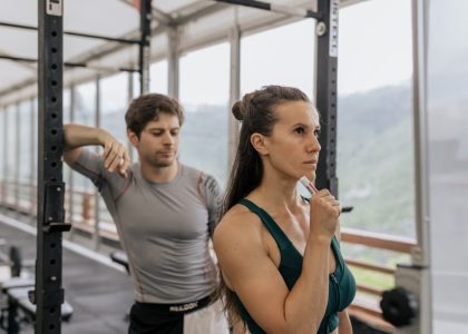 A fit couple engaged in gym exercises. Indoor workout with focus on fitness goals.